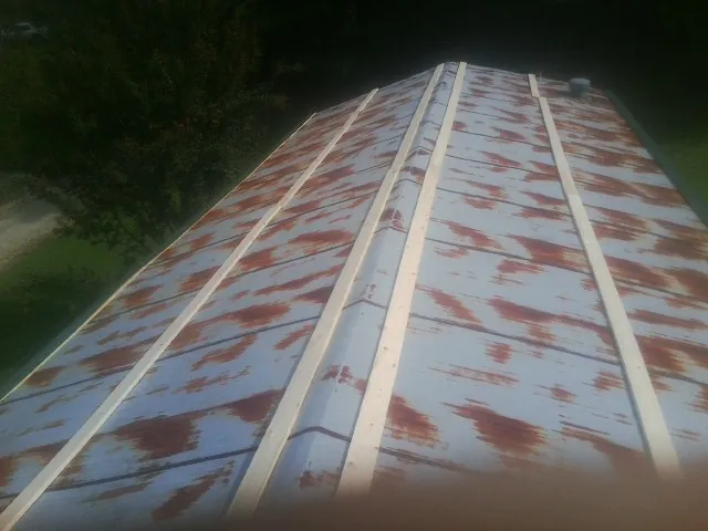 Rusted metal roof panels with new wood purlins before replacement — Storm Damage Roof Repair in Powell Butte by Roofing Brothers